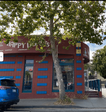 a red building with a tree in front of it